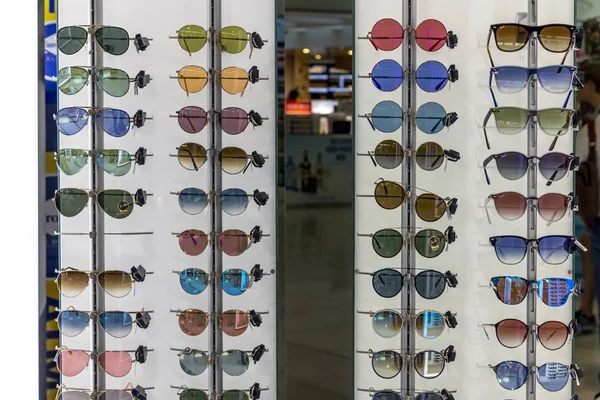 Larnaca, Cyprus - November 6. 2018. Sunglasses of famous brands in airport duty free shop — Stock Photo, Image