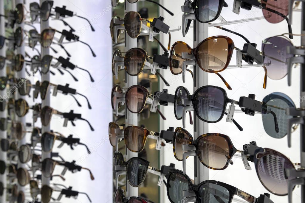 Larnaca, Cyprus - November 6. 2018. Glasses of famous brands in the airport duty free shop