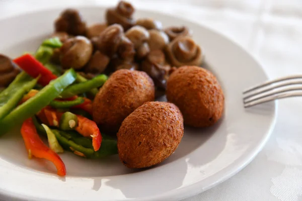 Potato balls and Fried mushrooms on plate — Stock Photo, Image