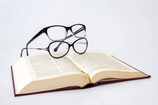 Two glasses for women with monofocal lenses and book — Stock Photo, Image