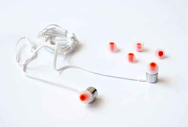 The white channel earphones on a white background — Stock Photo, Image