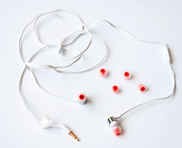 The white channel earphones on a white background — Stock Photo, Image