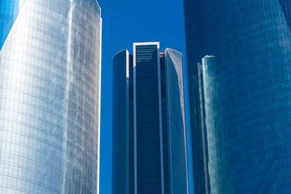 Modern glass skyscrapers against the blue sky in the afternoon — Stock Photo, Image