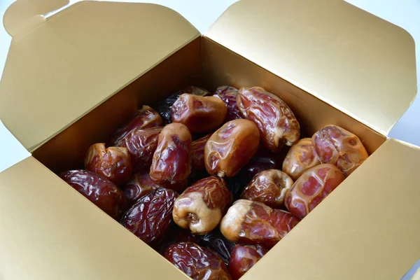 Dried dates in a box on white background — Stock Photo, Image