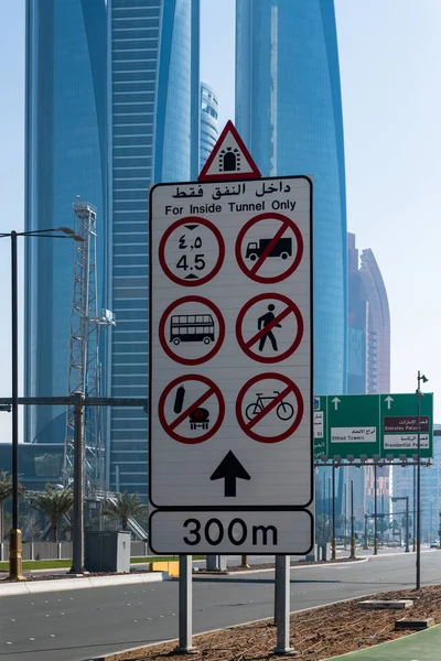 Abu Dhabi, UAE - March 30. 2019. road signs for inside tunnel on background of skyscrapers — Stock Photo, Image