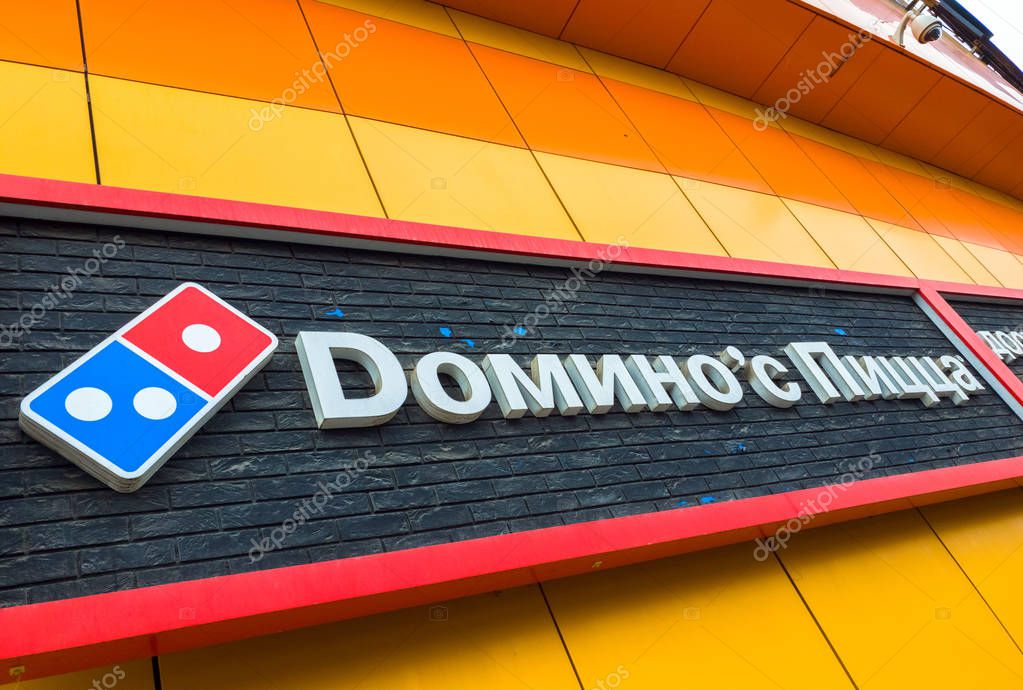 Moscow, Russia - March 21. 2019. Dominos pizza - USA international chain of fast food restaurants. Sign on wall of the building