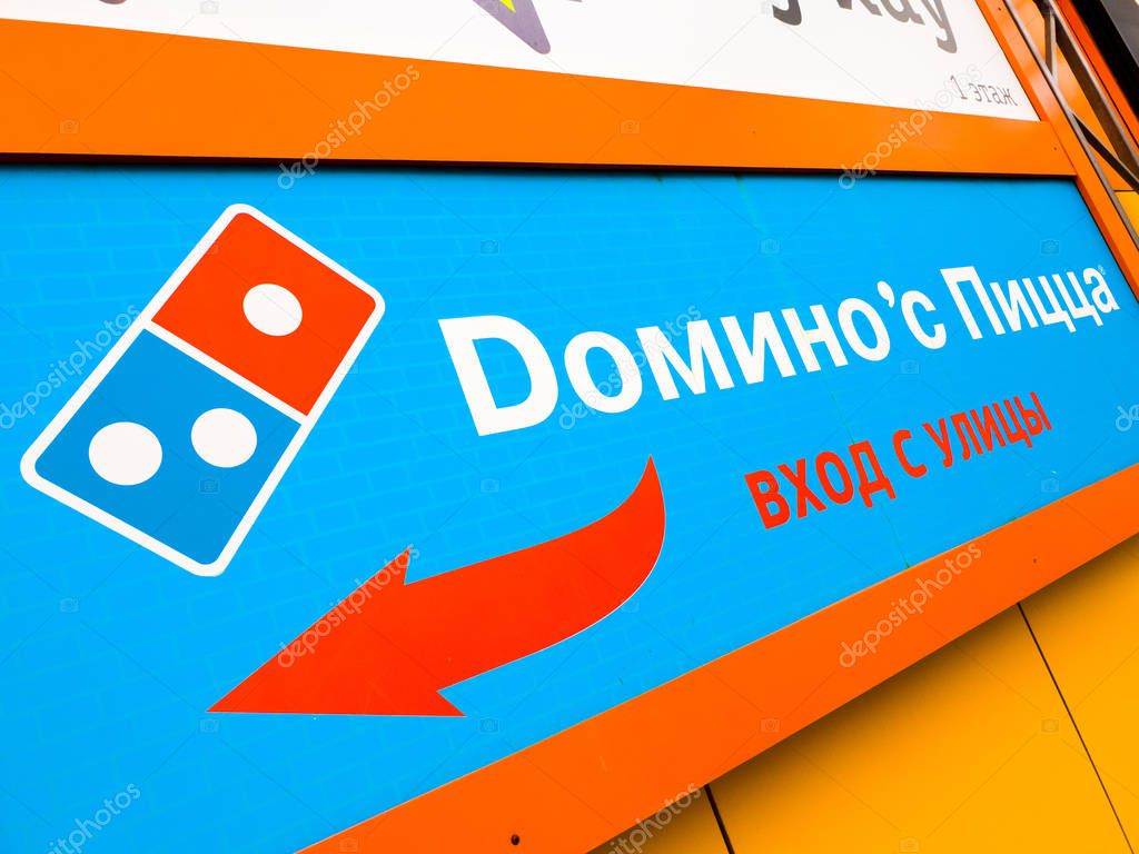 Moscow, Russia - March 21. 2019. Dominos pizza - USA international chain of fast food restaurants. Sign on wall of the building