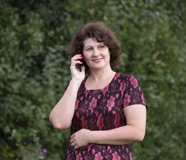 Γυναίκα στη φύση μιλάει σε ένα κινητό τηλέφωνο — Φωτογραφία Αρχείου