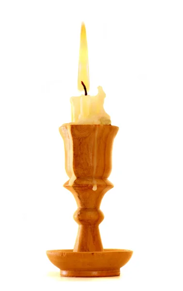 Burning old candle vintage wooden candlestick. Isolated on white background. — Stock Photo, Image