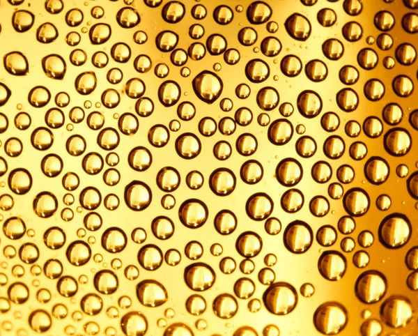 Spatten Van Waterdruppels Een Gele Achtergrond Close — Stockfoto