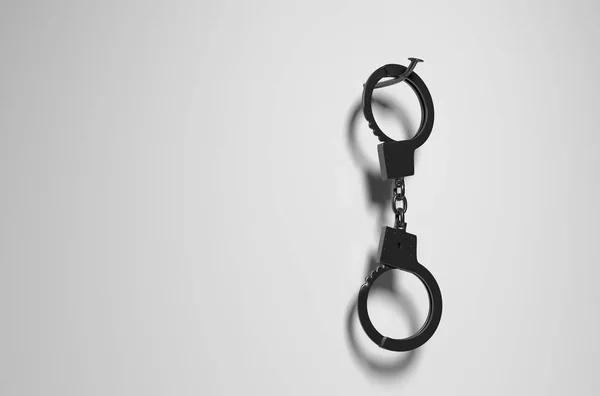 Dangling handcuffs on a nail. — Stock Photo, Image