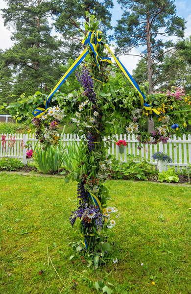 Midsummer pole in Swedish garden