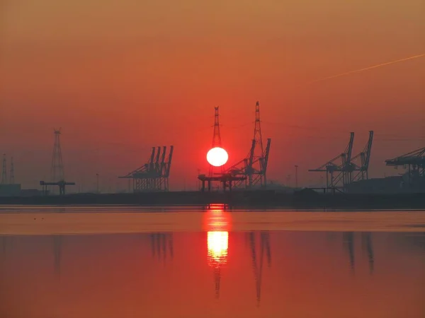 Sunrise in antwerp harbour — Stock Photo, Image