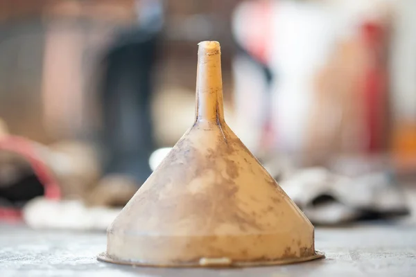 detail of old plastic funnel on wooden background