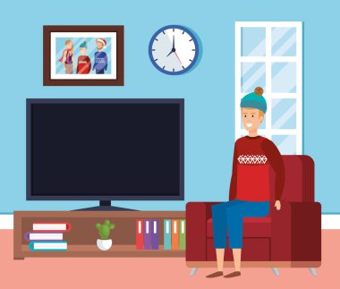 adam kış giysileri içinde oturma odası ile