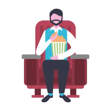 sinema koltuğunda oturan adam film izlerken