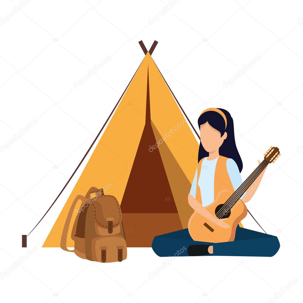 young woman playing guitar with camping tent and travelbag