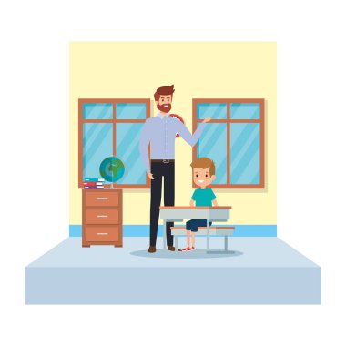 erkek öğretmen ve çocuk sınıfta masada oturan