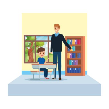 erkek öğretmen ve çocuk sınıfta masada oturan