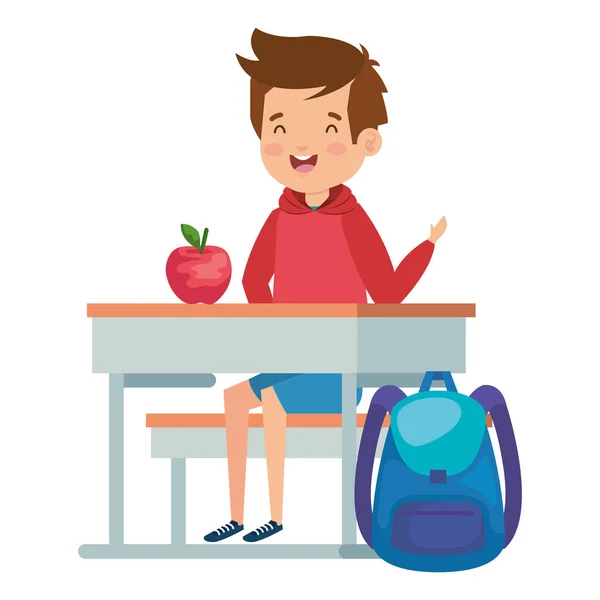 Uczeń chłopca siedzącego w szkole biurko z jabłkiem i torbą — Wektor stockowy