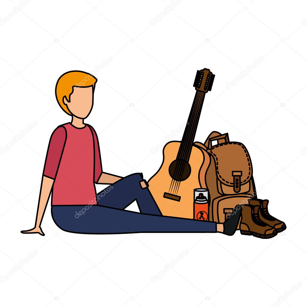 young man with guitar and camping equipment