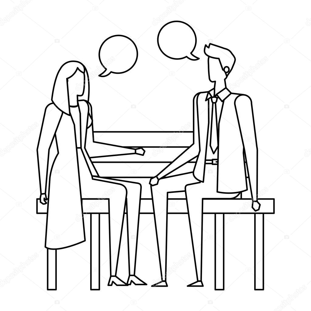 business couple seated in the park chair with speech bubbles