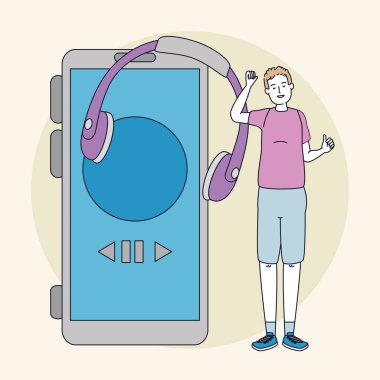 Kulaklığı ve akıllı telefonu olan genç bir adam.