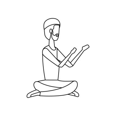 İslami adam geleneksel giysilerle dua oturmuş