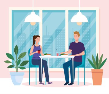 Yeni konsept restoranda sosyal mesafe, masada yemek yiyen çift, koruma, koronavirüsün önlenmesi, covid 19