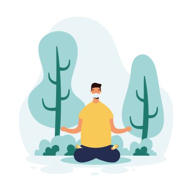 Adam parkta yoga yaparken maske takıyor.