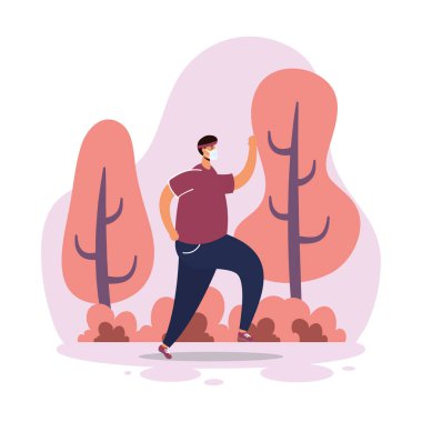 Adam parkta koşarken tıbbi maske takıyor.