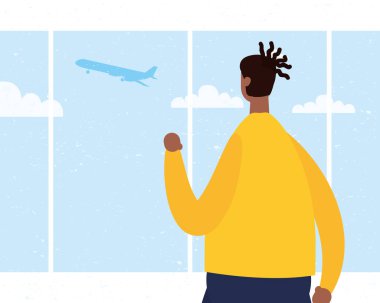 Bekleme odasında tıbbi maske takan afro genç adam.