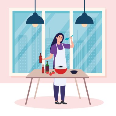 Kadın önlükle yemek pişiriyor, masada.