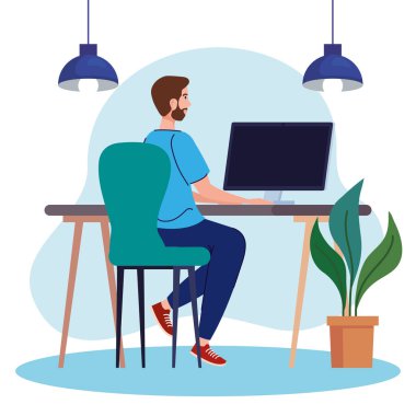 Genç adam masada bilgisayar kullanıyor, internette çalışıyor.