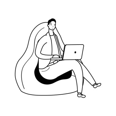 Dizüstü bilgisayarda çalışan genç adam kanepede oturuyor.