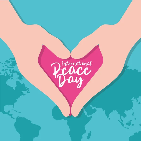 Día Internacional de la Paz escrito en el corazón con las manos y el planeta tierra — Archivo Imágenes Vectoriales