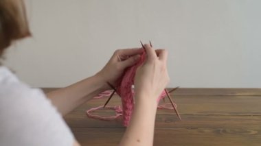 Ahşap bir masa, pembe şapka örgü