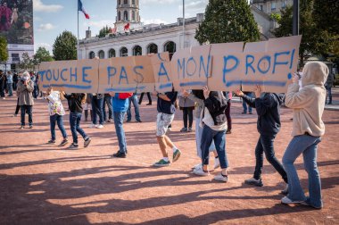 LYON, FRANCE - OCTOBER 18, 2020 : Anti terrorism protest after 3 days islamic terrorist attacks : Professor Samuel Paty was beheaded in front of his college after being accused of showing cartoons of Mohammed during a course on freedom of thought. clipart