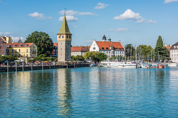 GERMANY, LINDAU - AUGUST 21: view of the Mangturm tower, the embankment and port of Lindau at lake Constance, Bodensee on August 21, 2015