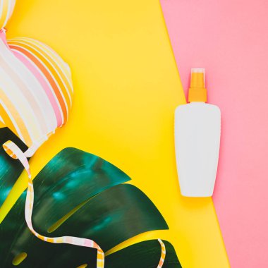 Tropikal orman palm monstera bırakır, güneş gözlüğü, Güneş kremi boş şişe mockup ve kadının mayo üst parlak kare renkli kağıt arka plan üzerinde. Yaz tatil yaratıcı düz yatıyordu kavramı şablonu