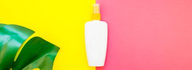 Tropikal orman palmiye monstera yaprakları ve güneş koruyucu boş şişe mockup parlak sarı ve pembe çift ton kağıt arka plan üzerinde. Yaz yaratıcı düz yatıyordu kavramı Şablon metnini tatiller. Uzun geniş afiş