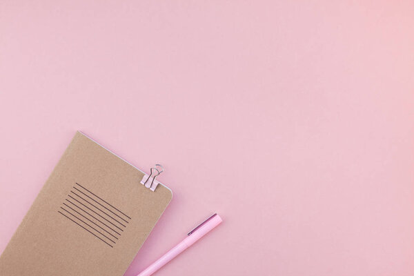 Top view flat lay of woman workspace desk styled design office supplies with copy space on a millennial pink color paper background minimal style. Template for feminine blog social media