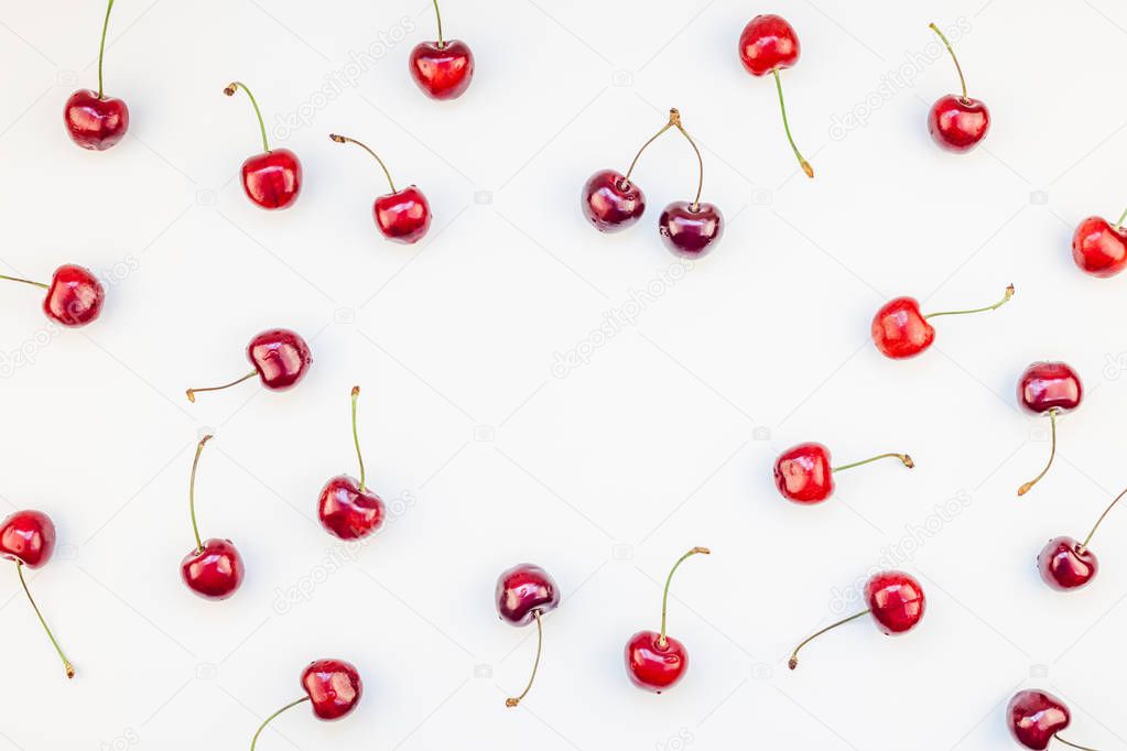 Creative top view of fresh ripe cherry pattern layout with copy space isolated on white background in minimal style. Concept of summer fun and healthy eating. Template for your text or food design