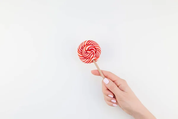 Mão Mulher Com Manicure Pastel Polonês Segurando Pirulito Girando Vermelho — Fotografia de Stock