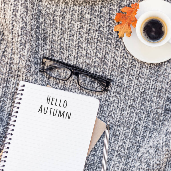 Creative square autumn flat lay overhead view stylish home workspace with notebook coffee cup cozy gray knitted plaid background copy space. Осенний сезон поздравления женский блог в социальных сетях

