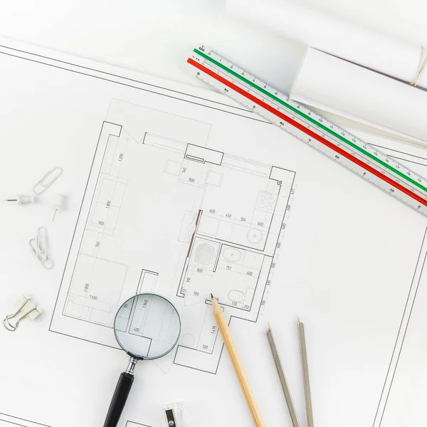 Creative flat lay overhead top view blueprints architectural flat project plan and office supplies on decorator square table workspace with swatches tools and equipment background copy space concept