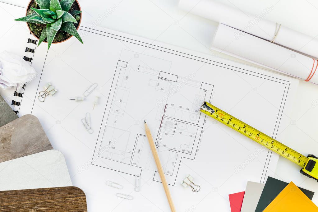 Creative flat lay overhead top view blueprints architectural flat project plan and office supplies on decorator white table workspace with swatches tools and equipment background copy space concept