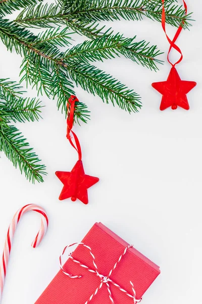 Gift boxes, candy canes and cypress branches. Christmas preparation of  gifts on red and beige wrapping paper. New Year concept. Top view, flat lay  Stock Photo - Alamy