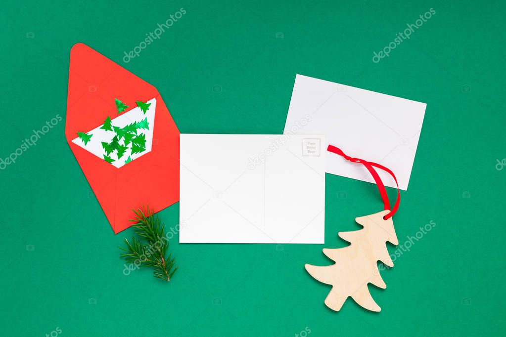Creative New Year or Christmas greetings letter mockup flat lay top view Xmas holiday celebration envelope on green paper background. Template mock up greeting card or your text design 2019 2020