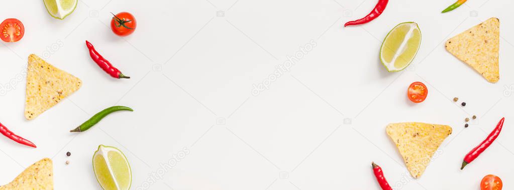 Creative Top view flat lay fresh mexican food ingredients with tortilla nachos chips garlic pepper lime tomatoes on white background copy space. Food preparation cooking concept frame Long wide banner